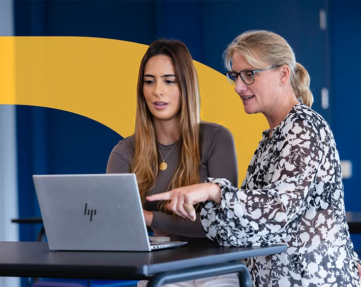 image of 2 women looking at laptop