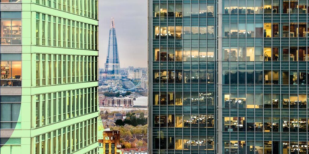 A view over London, skyscrapers in the foreground, the Shard in the distance