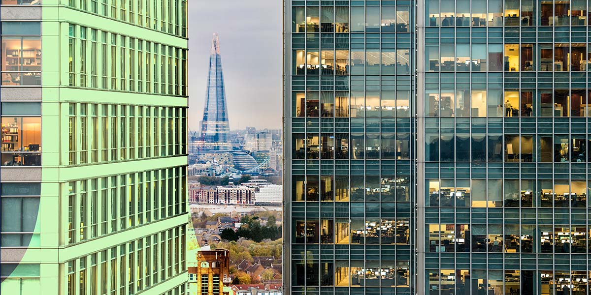 A view over London, skyscrapers in the foreground, the Shard in the distance
